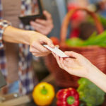 CPI Data: Food Prices Increased in February Hand of customer giving credit card to supermarket cashier at checkout