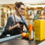 Food Prices Climb 0.9% During April: CPI Report Smiling female cashier scanning grocery items at supermarket