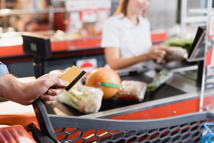 Cropped View Of Man Holding Credit Card Near Shopping Cart And S