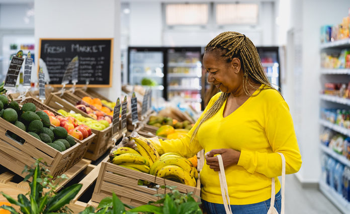 Senior African Woman Buying Fresh Fruits In Supermarket