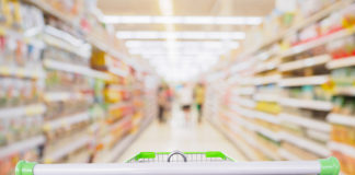 24% of Food and Beverage Dollars Now Go to Private Label. Which of Your SKUs Will Survive? Supermarket Aisle With Empty Shopping Cart At Grocery Store Reta