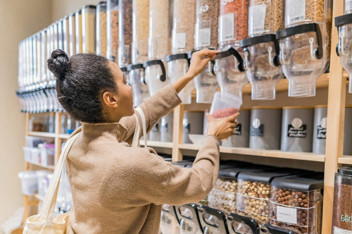 Young African American Woman Buying Cereals And Grains In Sustai