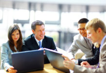 How Consumer Markets and Industrial Products Execs Are Preparing for the Economic Future Business meeting - manager discussing work with his colleagues