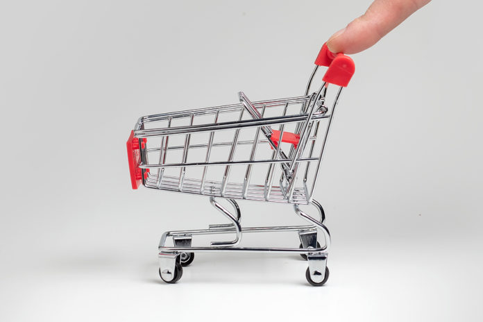 Human Finger Pushes Empty Grocery Shopping Cart. Isolated On Whi