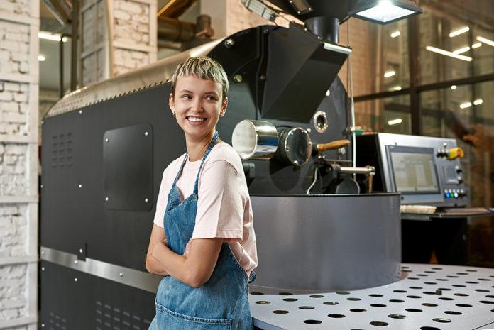 Young Caucasian Female Worker Or Business Owner Near Industrial