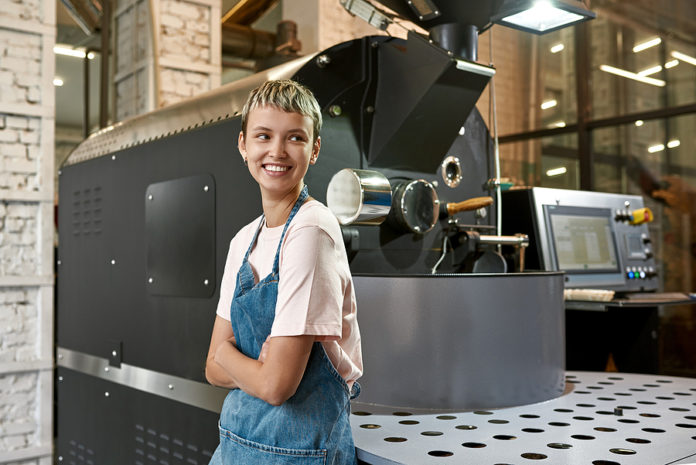 Young Caucasian Female Worker Or Business Owner Near Industrial Young Caucasian Female Worker Or Business Owner Near Industrial