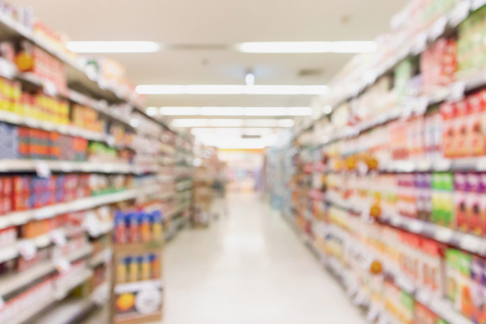 Empty Supermarket Aisle With Product On Shelves Blurred Backgrou