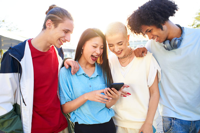 Gen Z Young Students Using Smartphone And Social Networks Togeth