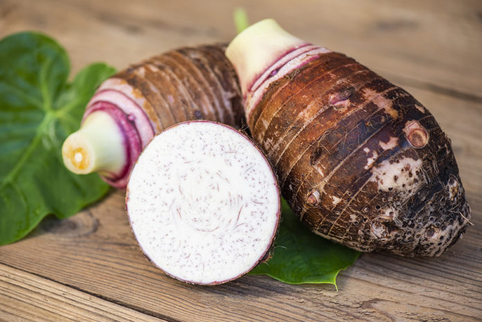 Taro Root With Half Slice On Taro Leaf And Wooden Background, Fr