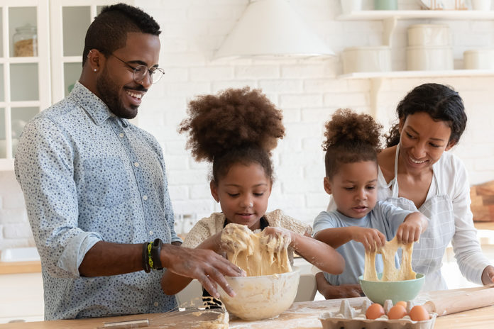 Funny African American Parents Helping Cute Kids To Knead Dough