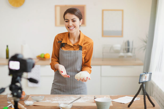 Portrait Of Beautiful Young Woman Holding Fresh Batter And Smili
