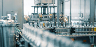 Companies Are Closing Plants and Cutting Jobs Based on These Four Figures Production Line Transports Empty Glass Bottles For Alcohol Drink