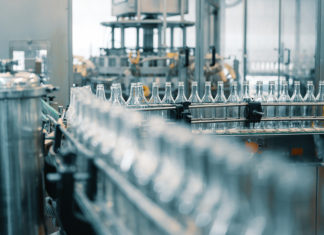 Companies Are Closing Plants and Cutting Jobs Based on These Four Figures Production Line Transports Empty Glass Bottles For Alcohol Drink