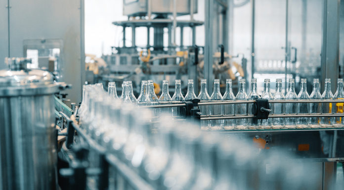 Companies Are Closing Plants and Cutting Jobs Based on These Four Figures Production Line Transports Empty Glass Bottles For Alcohol Drink