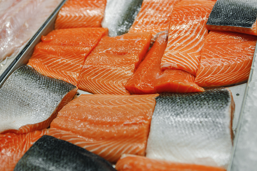 Fresh fish assorted on ice counter in supermarket