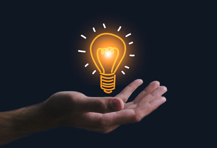 Innovation. Hands Holding Light Bulb For Concept New Idea Concep