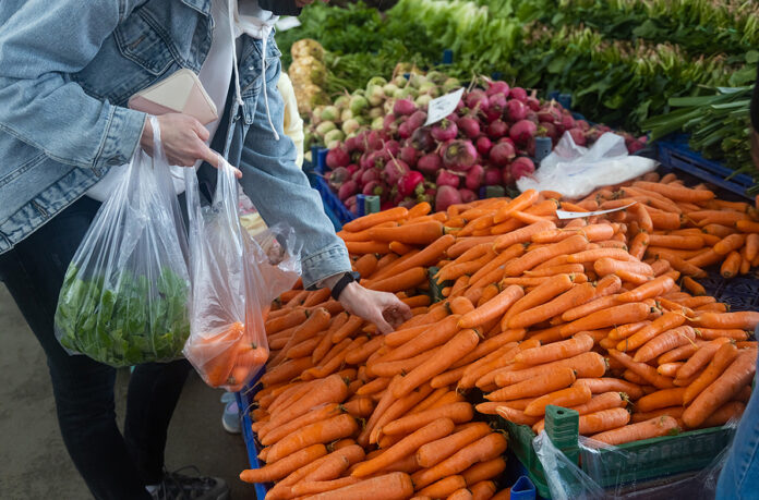 Buying Fresh Organic Produce At The Farmers Market. A Woman Choo