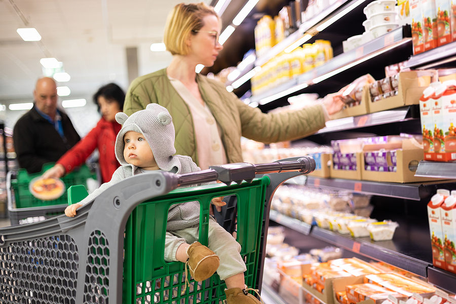 Casualy Dressed Mother Choosing Products In Department Of Superm