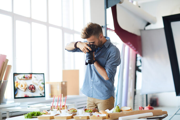 Portrait Of Male Photographer Doing Food-photography While Worki