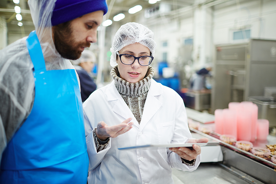 Colleagues from seafood processing plant discussing online data