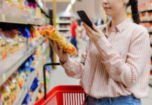 Precision, Traceability, and Trust: Q&A With Hitachi on How Smarter Marking and Coding Strengthen Food Manufacturing Shopping And Sales. Close Up Of Young Caucasian Woman Scan Qr Co