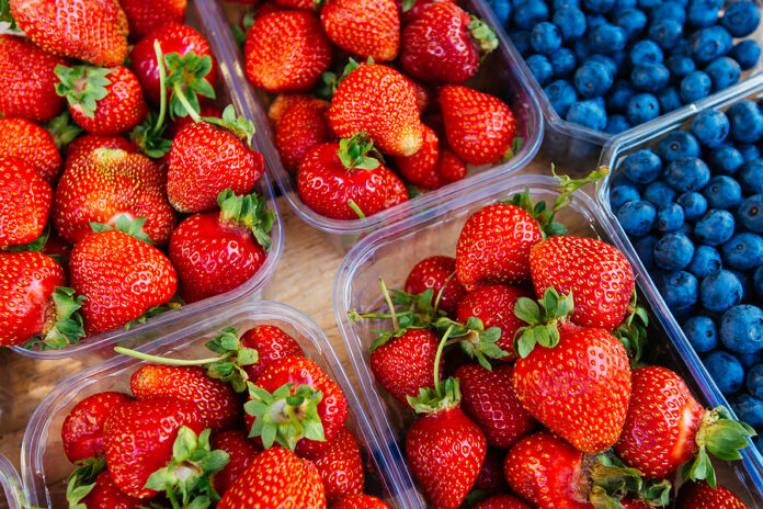 Blueberries and strawberries on the market counter