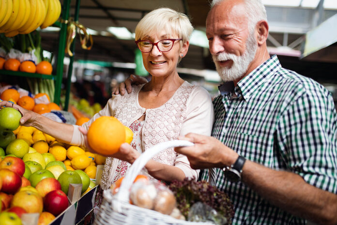 Senior Family Couple Choosing Bio Food Fruit And Vegetable On Th