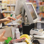 Food Prices Continue Steady Rise in September: CPI Report Woman customer paying via credit card using NFC technology in shopping mall