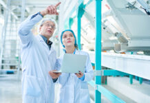 Building a Resilient F&B Workforce in 2026: Strategic Perspectives from NC Workforce Leaders John Loyack and Chris Reedy Portrait Of Senior Factory Worker Wearing Lab Coat Explaining Ru