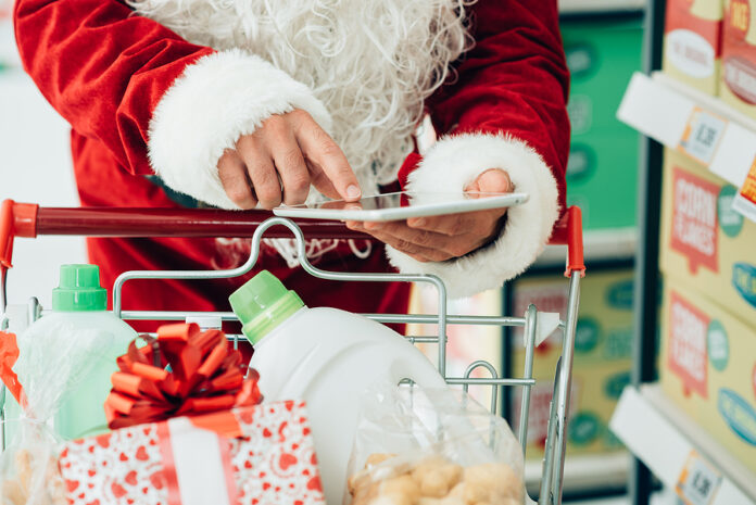 Santa Using A Tablet At The Supermarket