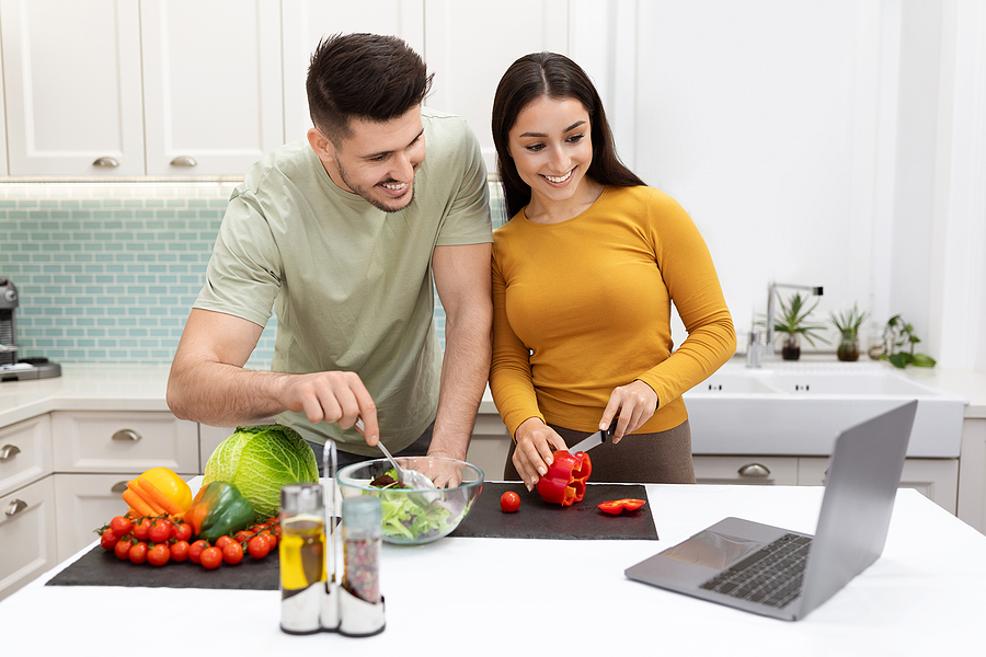 Cheerful Beautiful Young Couple Preparing Dinner Together, Watch