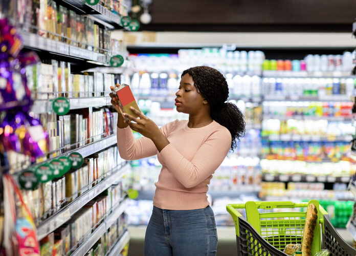 Pretty African American Woman Choosing Groceries At Supermarket,