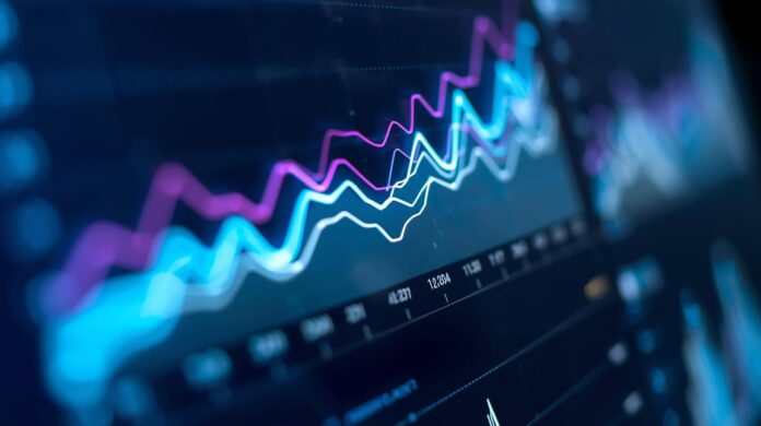 Close-up of a digital dashboard display showing trend lines and data visualizations, shallow depth of field, no visible text or labels, clean and minimal composition.